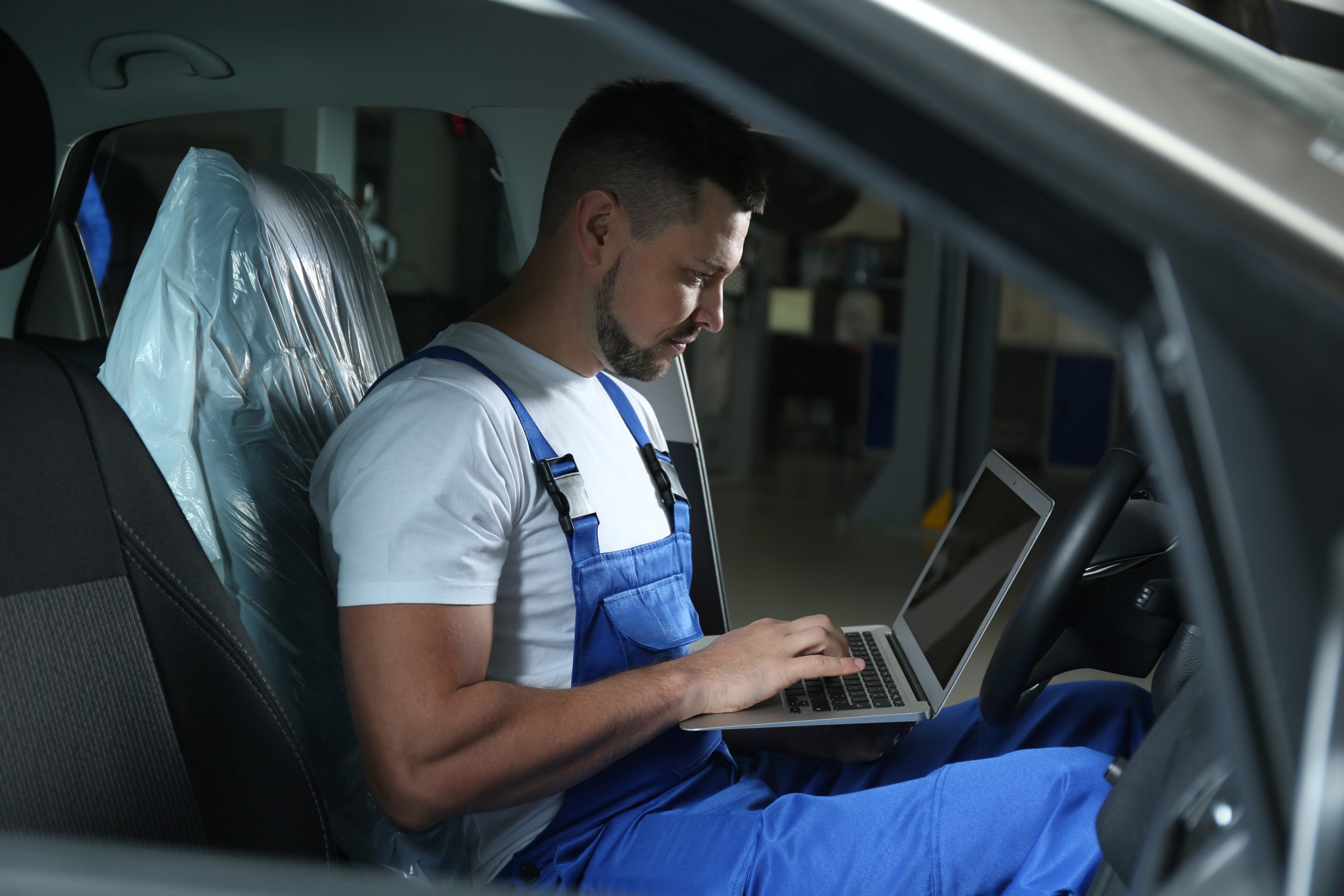 Installer in a vehicle working with a laptop